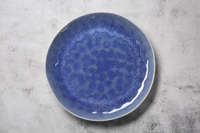 Photo of One blue plate on light table, top view