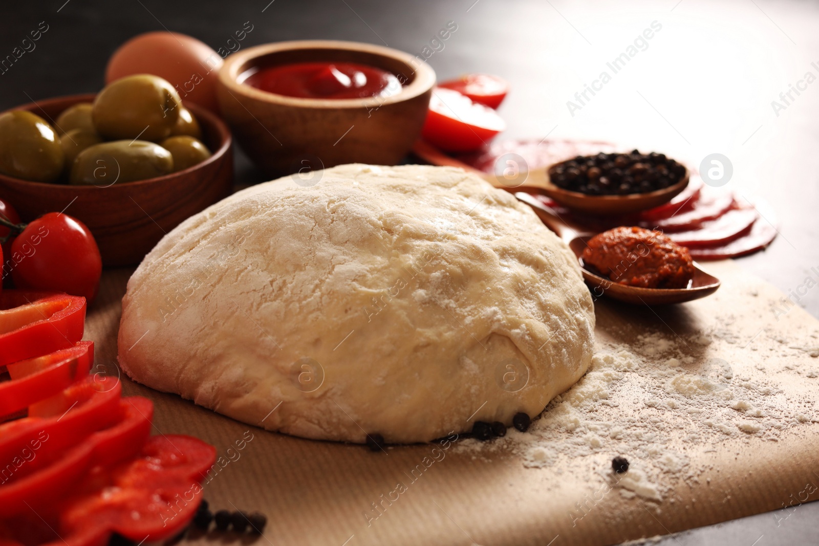 Photo of Pizza dough and products on table, closeup