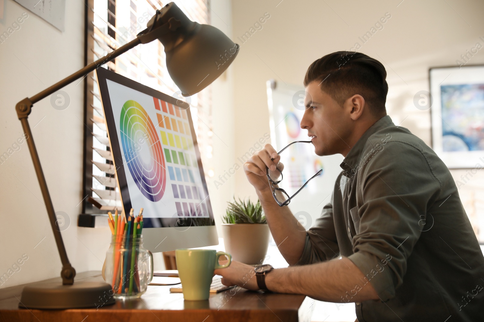 Photo of Professional designer working with computer in office