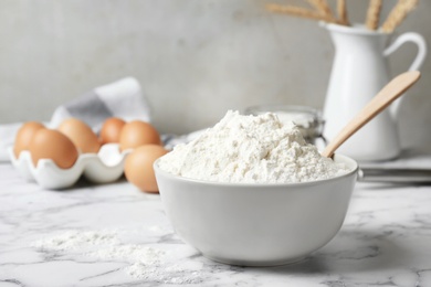 Photo of Bowl with flour on table