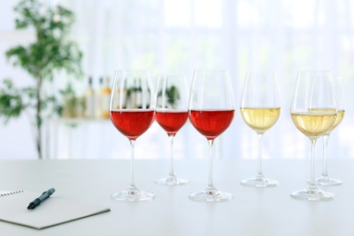 Glasses with delicious wine on table indoors