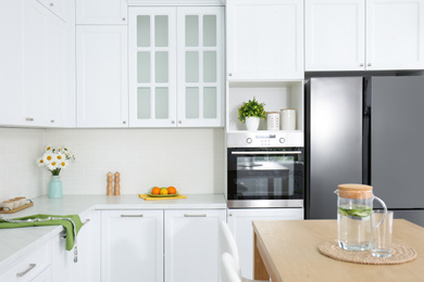 Photo of Beautiful kitchen interior with stylish wooden table