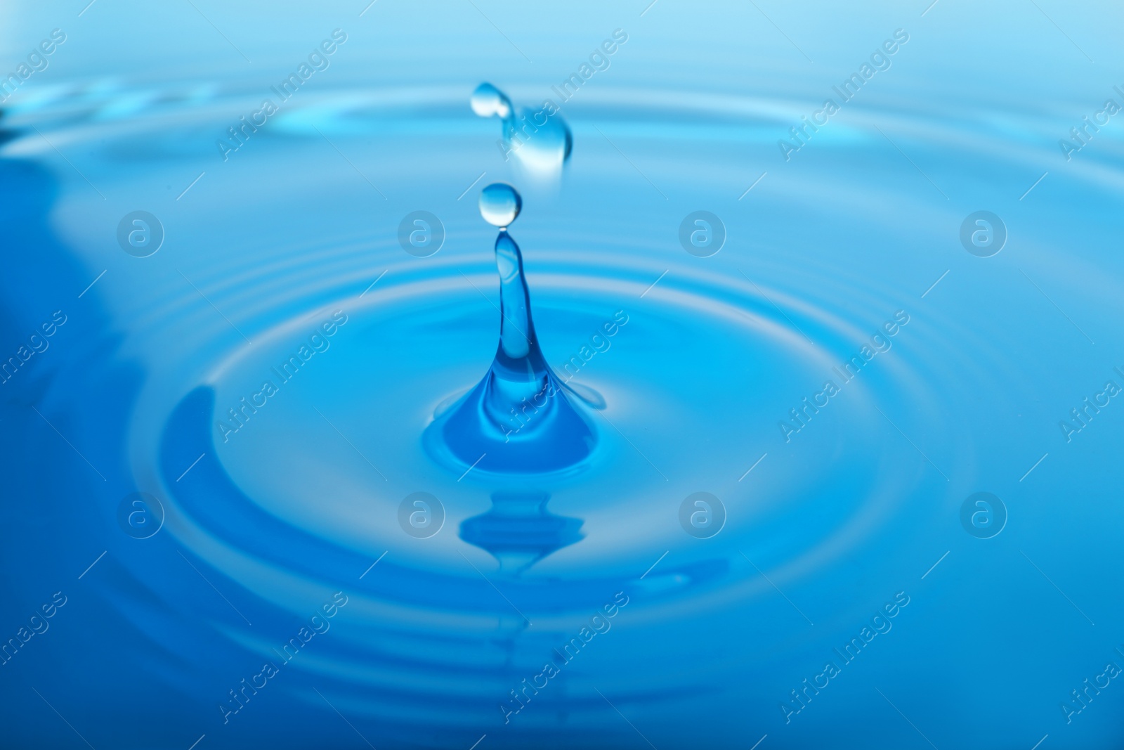 Photo of Splash of blue water with drop as background, closeup