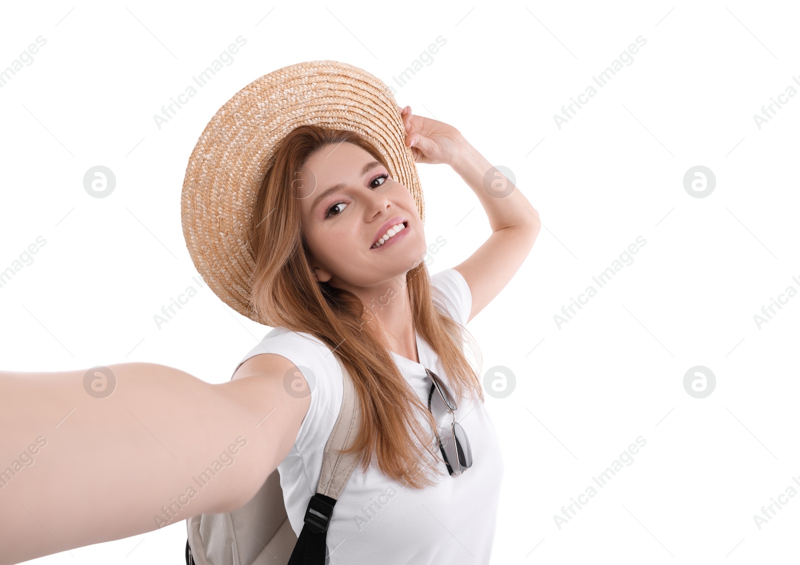 Photo of Beautiful woman in straw hat taking selfie on white background