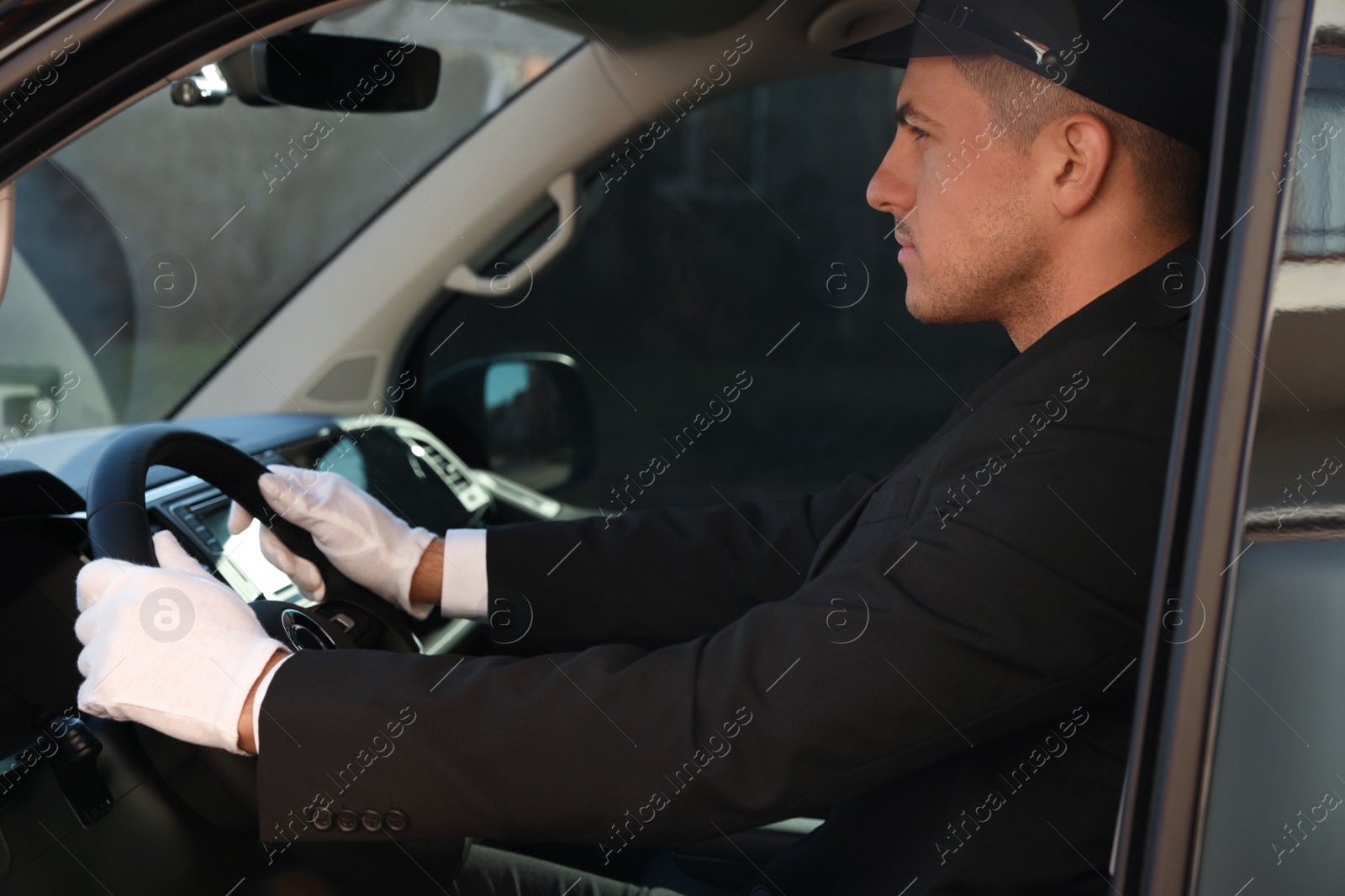 Photo of Professional driver in luxury car. Chauffeur service