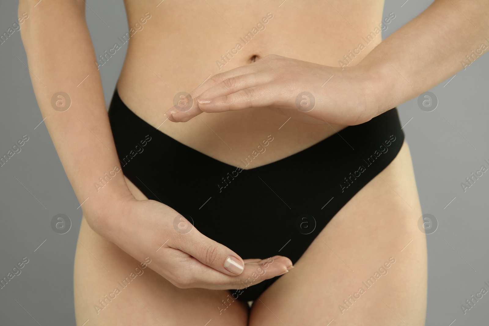 Photo of Gynecology. Woman in underwear on grey background, closeup