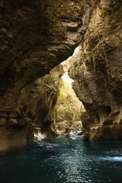 Photo of Picturesque view of clean river near cliffs and waterfall outdoors