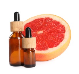 Photo of Bottles of citrus essential oil and fresh grapefruit on white background
