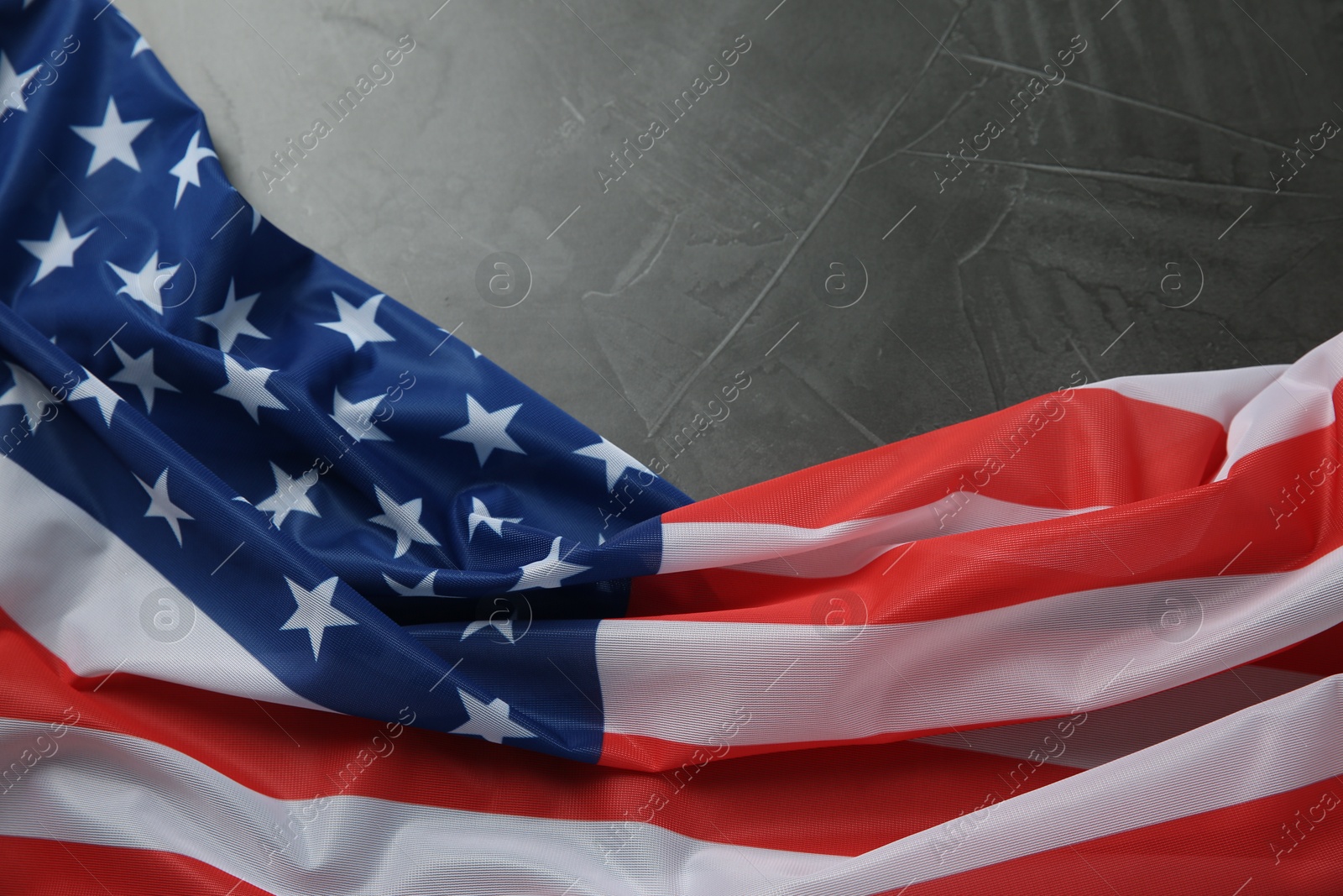 Photo of Flag of USA on black table, top view. Space for text