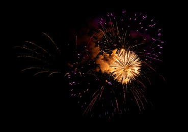 Image of Beautiful bright fireworks lighting up night sky