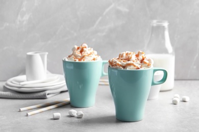 Photo of Cups with delicious caramel frappe on table