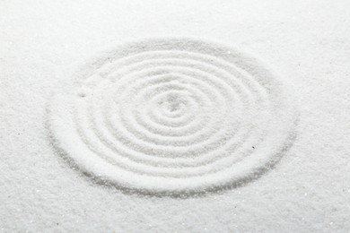 Photo of Zen rock garden. Circle pattern on white sand