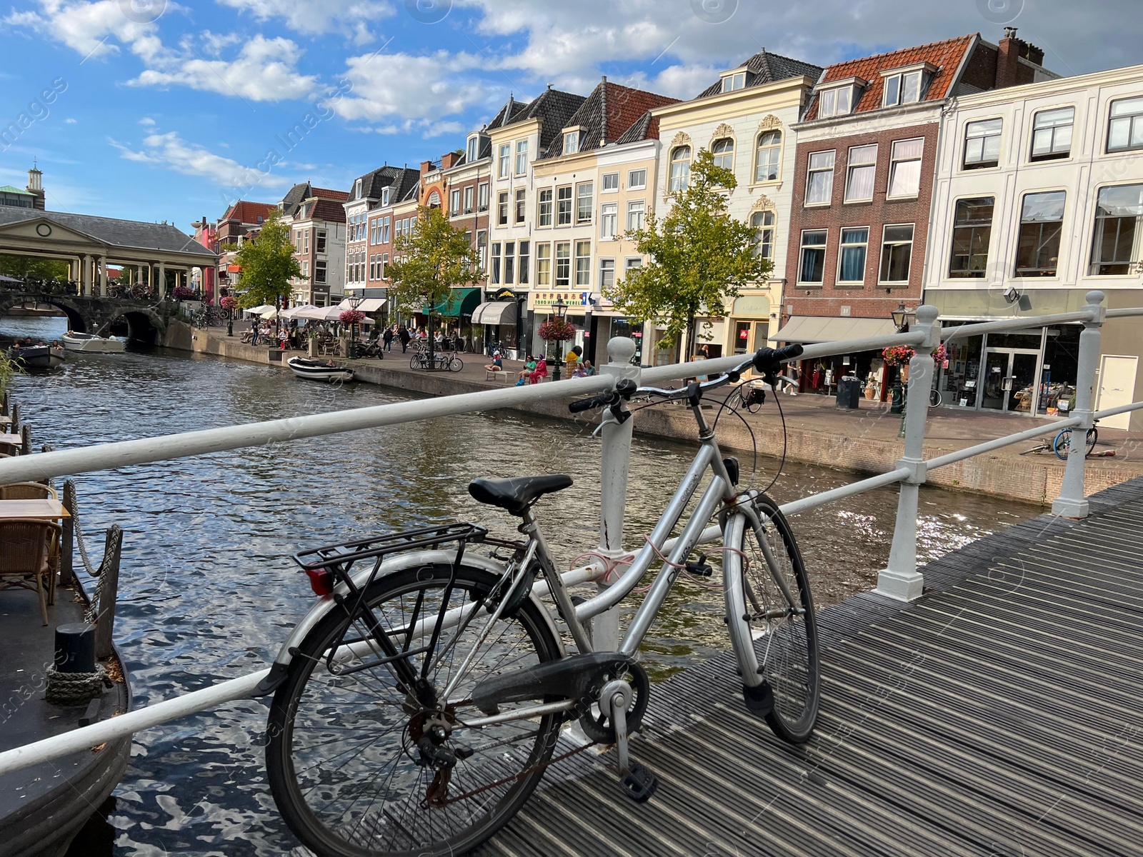 Photo of Beautiful view of bicycle on pedestrian bridge near canal in city