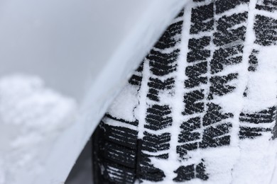 Photo of Car with winter tires covered with snow, closeup
