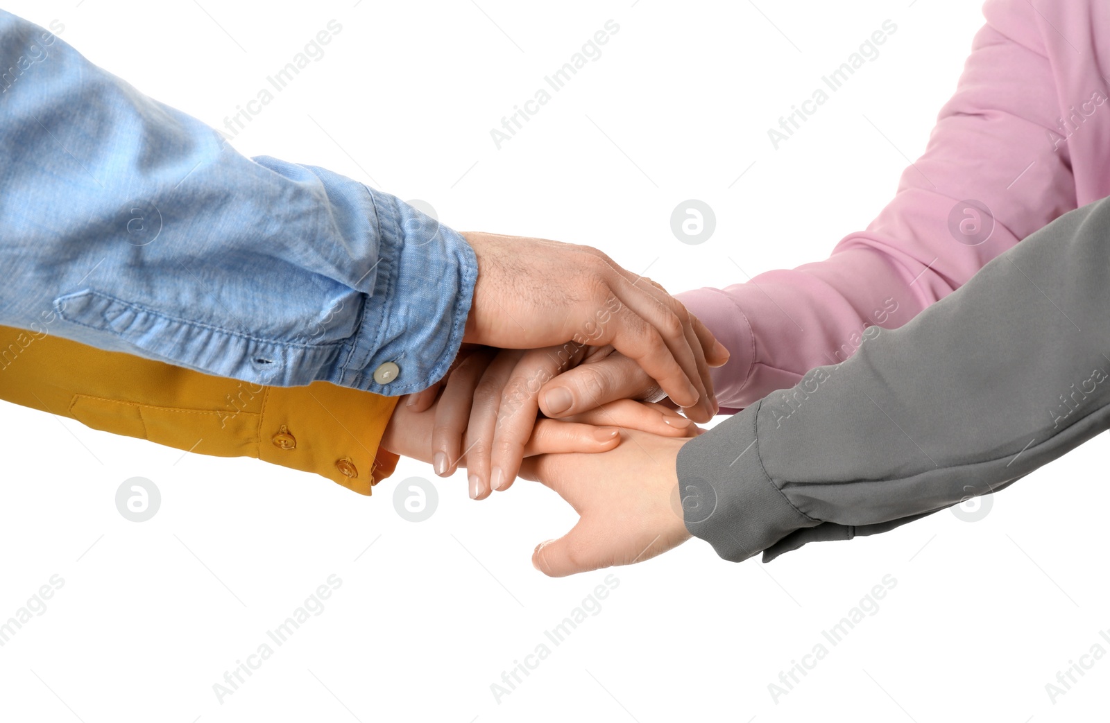 Photo of Young people putting their hands together on white background, closeup