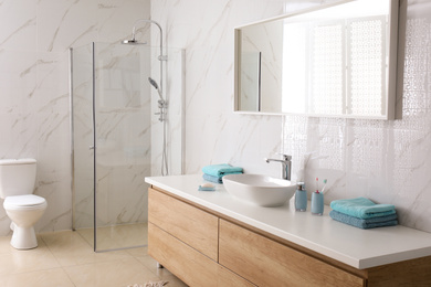 Photo of Modern mirror and vessel sink in stylish bathroom