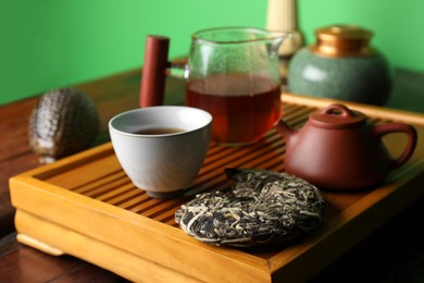 Photo of Traditional tea ceremony arrangement on wooden table, closeup