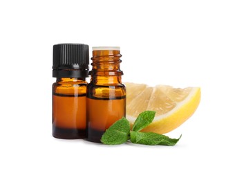 Bottles of citrus essential oil and cut fresh lemon isolated on white