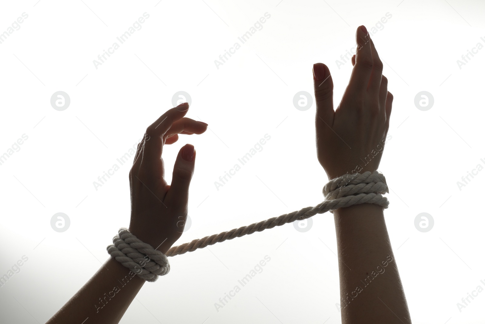 Photo of Freedom concept. Woman with tied arms on white background, closeup