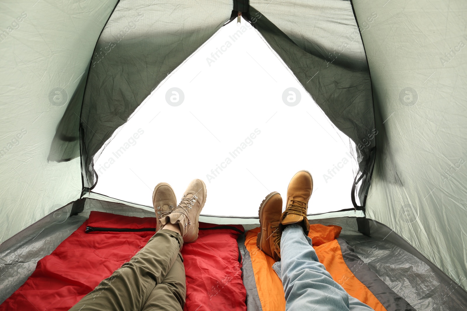 Photo of Closeup of couple in camping tent on white background, view from inside