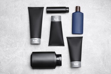 Photo of Flat lay composition with set of men's cosmetic products on light grey background