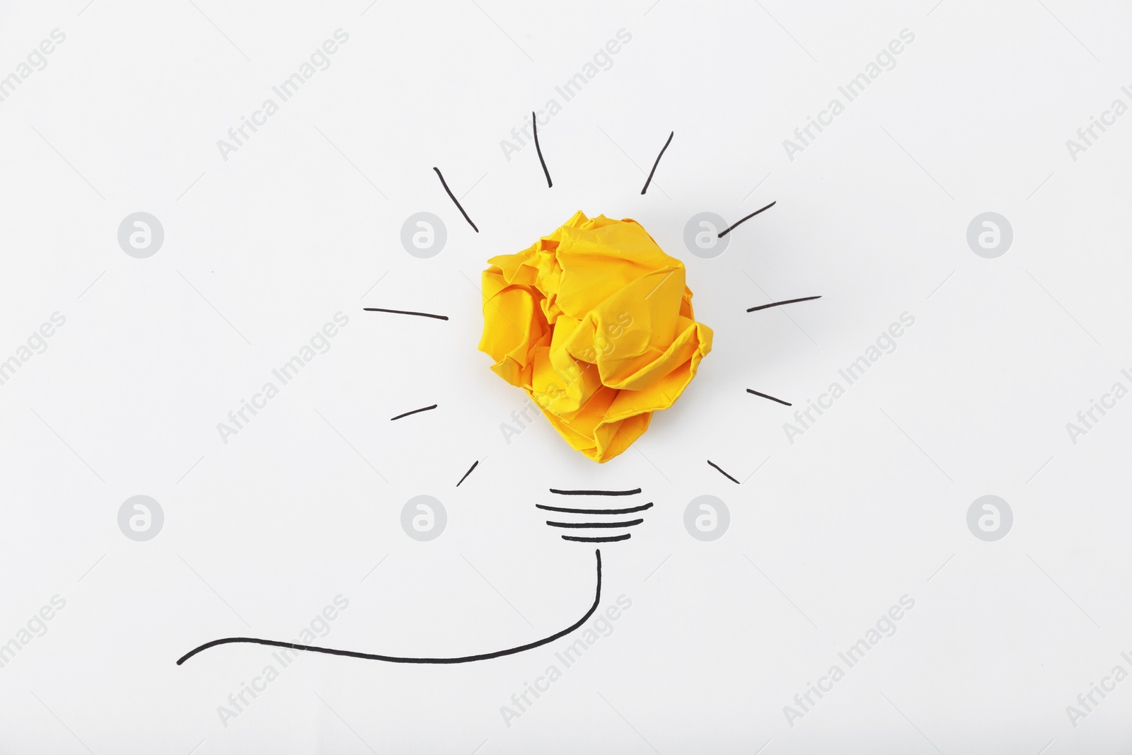 Photo of Composition with crumpled paper ball and drawing of lamp bulb on white background, top view. Creative concept