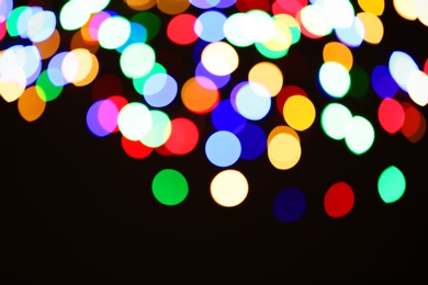 Photo of Beautiful colorful lights on dark background. Bokeh effect