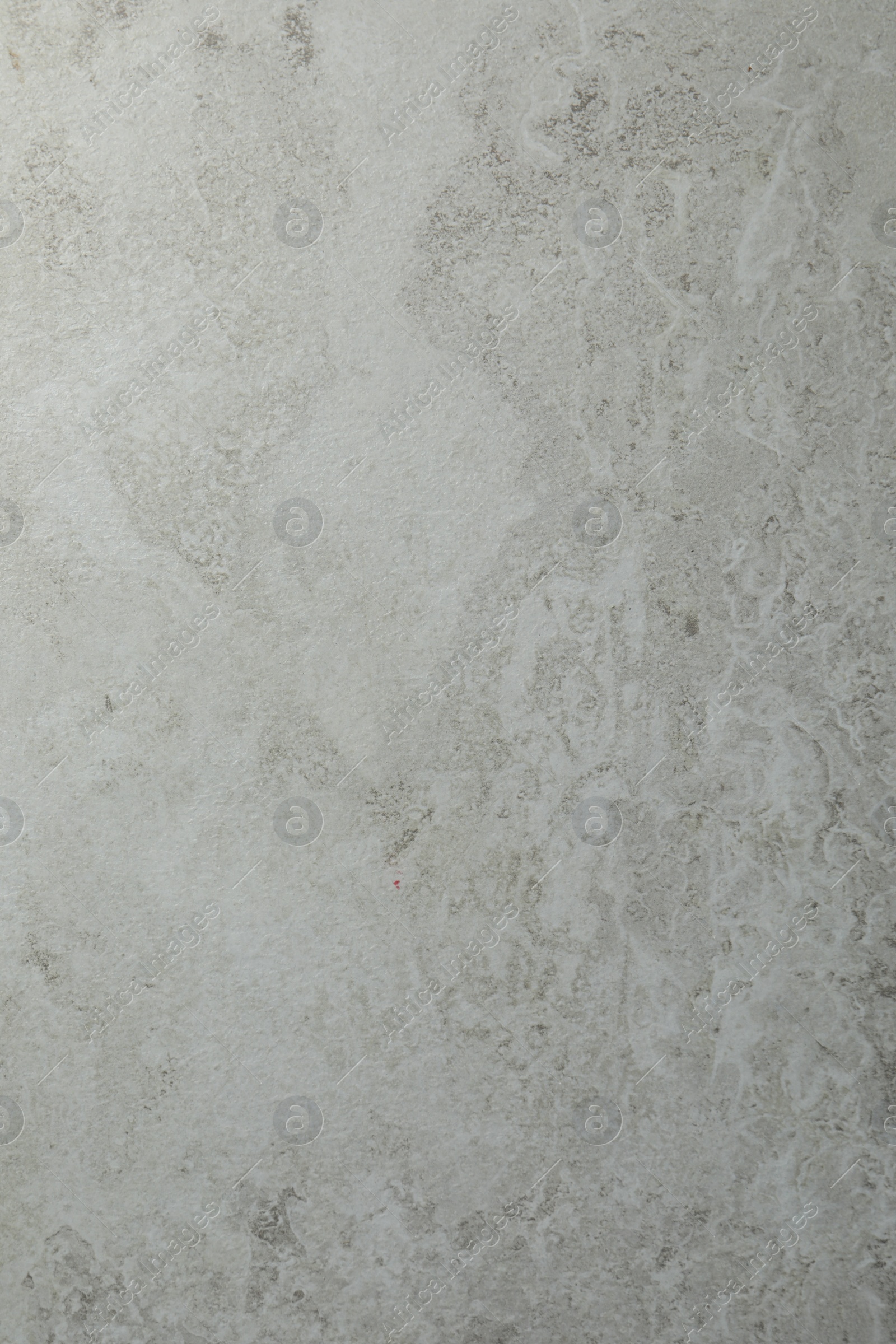 Photo of Texture of light grey stone surface as background, closeup