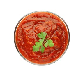 Delicious adjika sauce and parsley in bowl isolated on white, top view