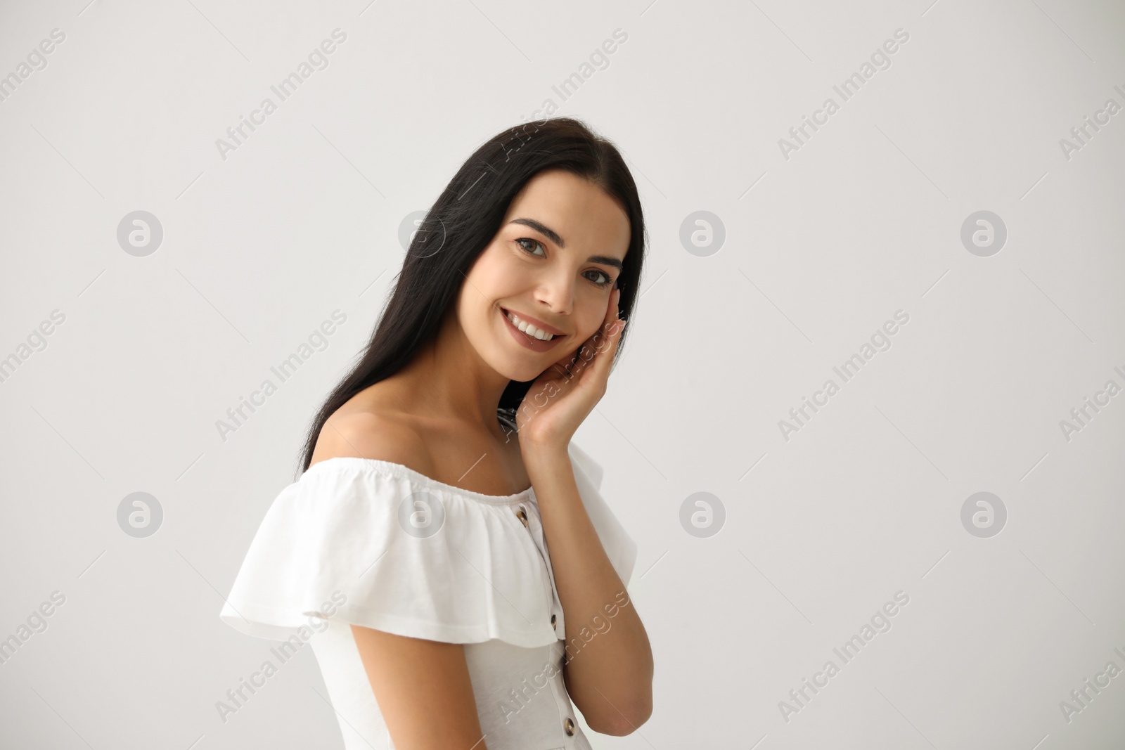 Photo of Beautiful young woman on light grey background