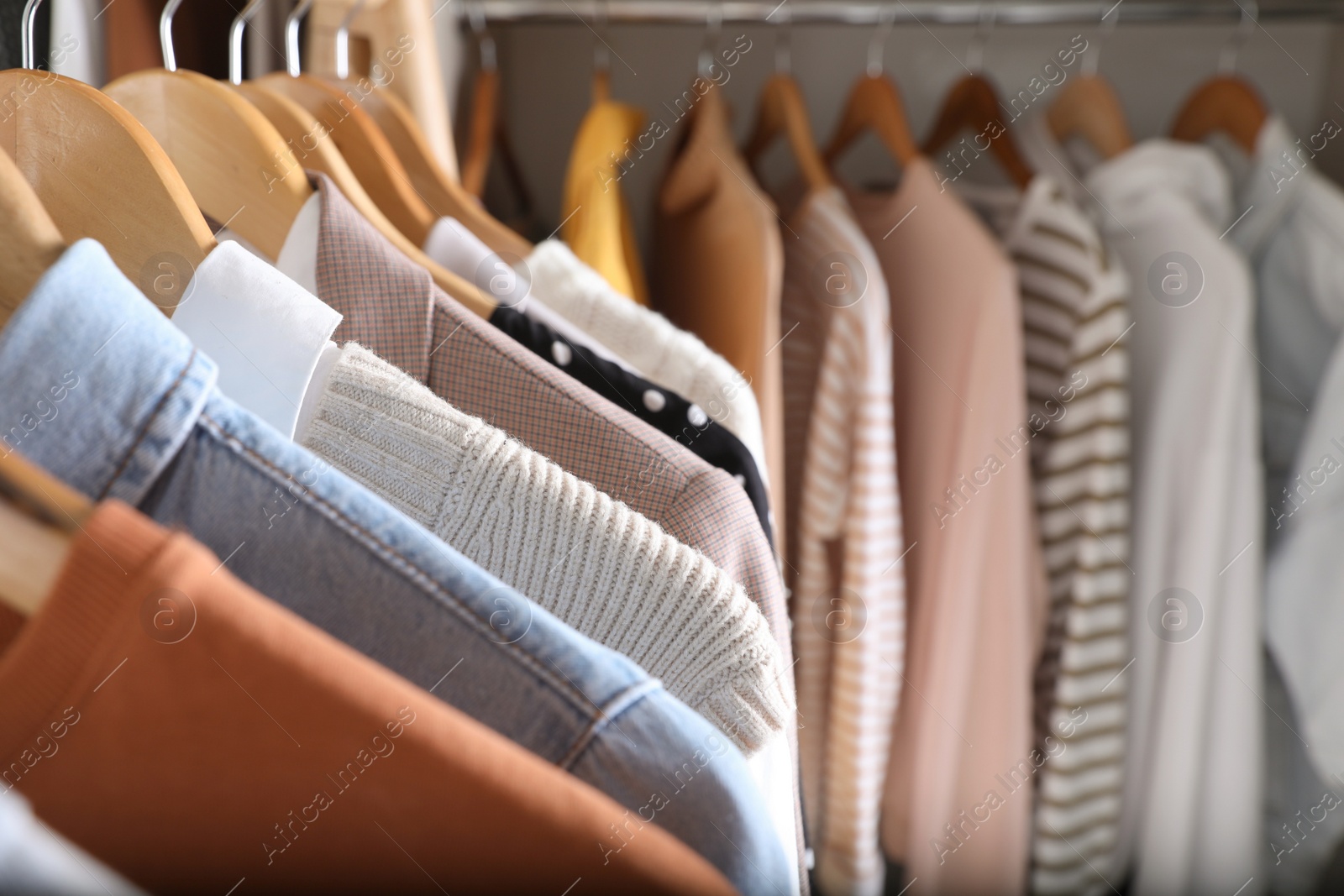 Photo of Wardrobe closet with different stylish clothes, closeup