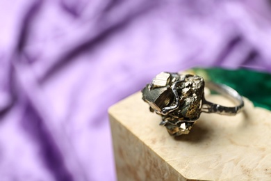 Beautiful silver ring with pyrite gemstones on color background. Space for text