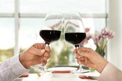 People with glasses of wine on blurred background, closeup