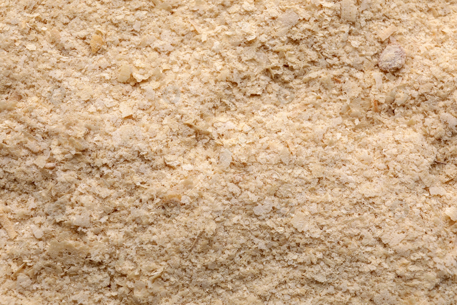 Photo of Brewer`s yeast flakes as background, closeup view