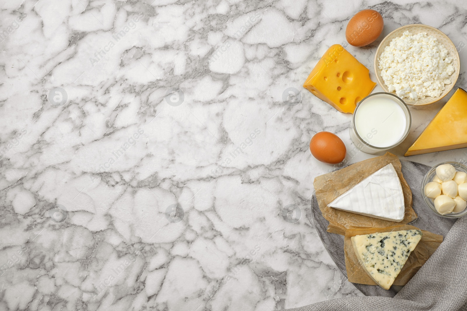 Photo of Different dairy products on marble table, flat lay. Space for text