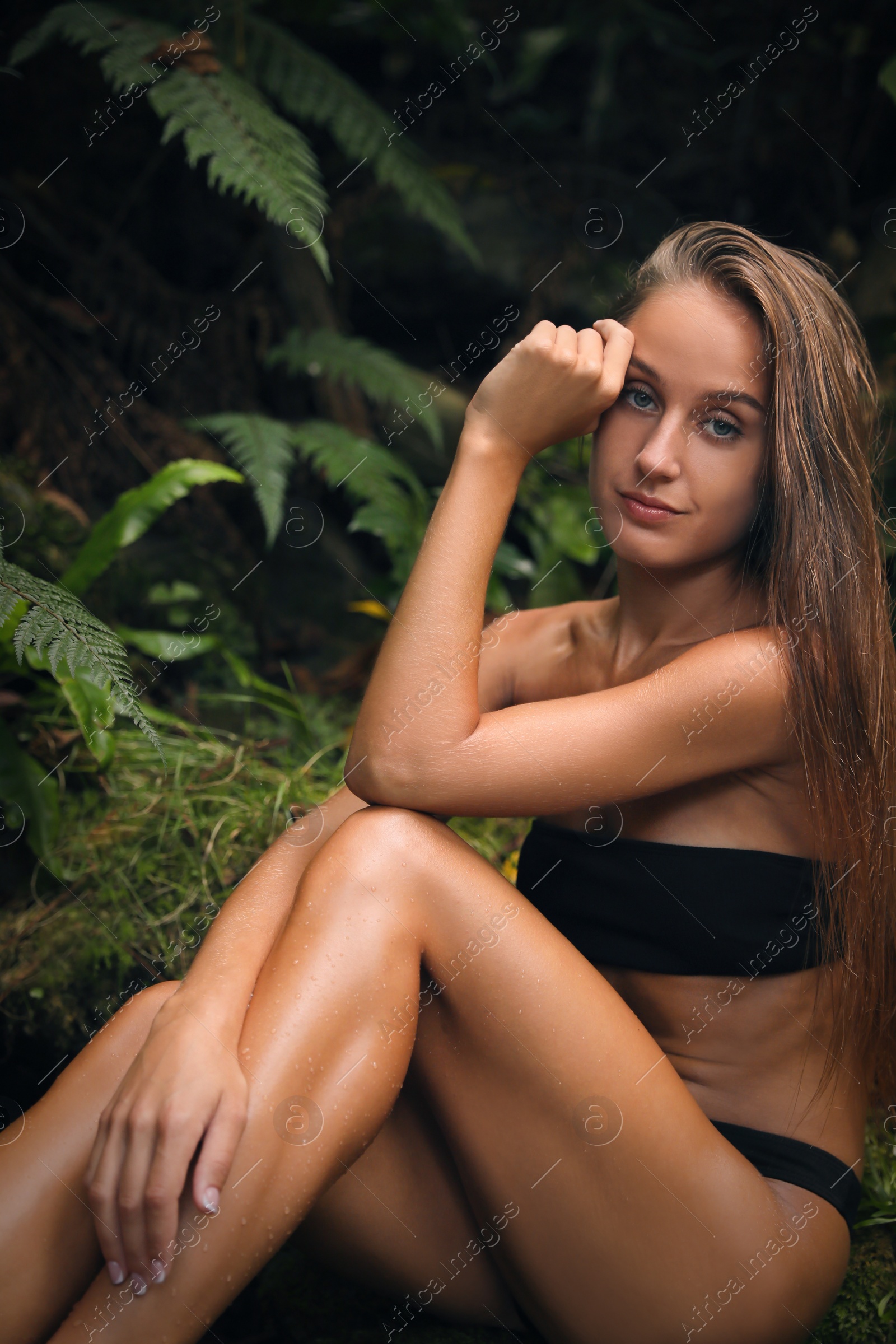 Photo of Beautiful young woman relaxing in tropical forest