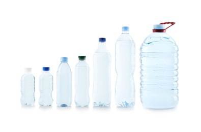 Set of different plastic bottles with pure water on white background