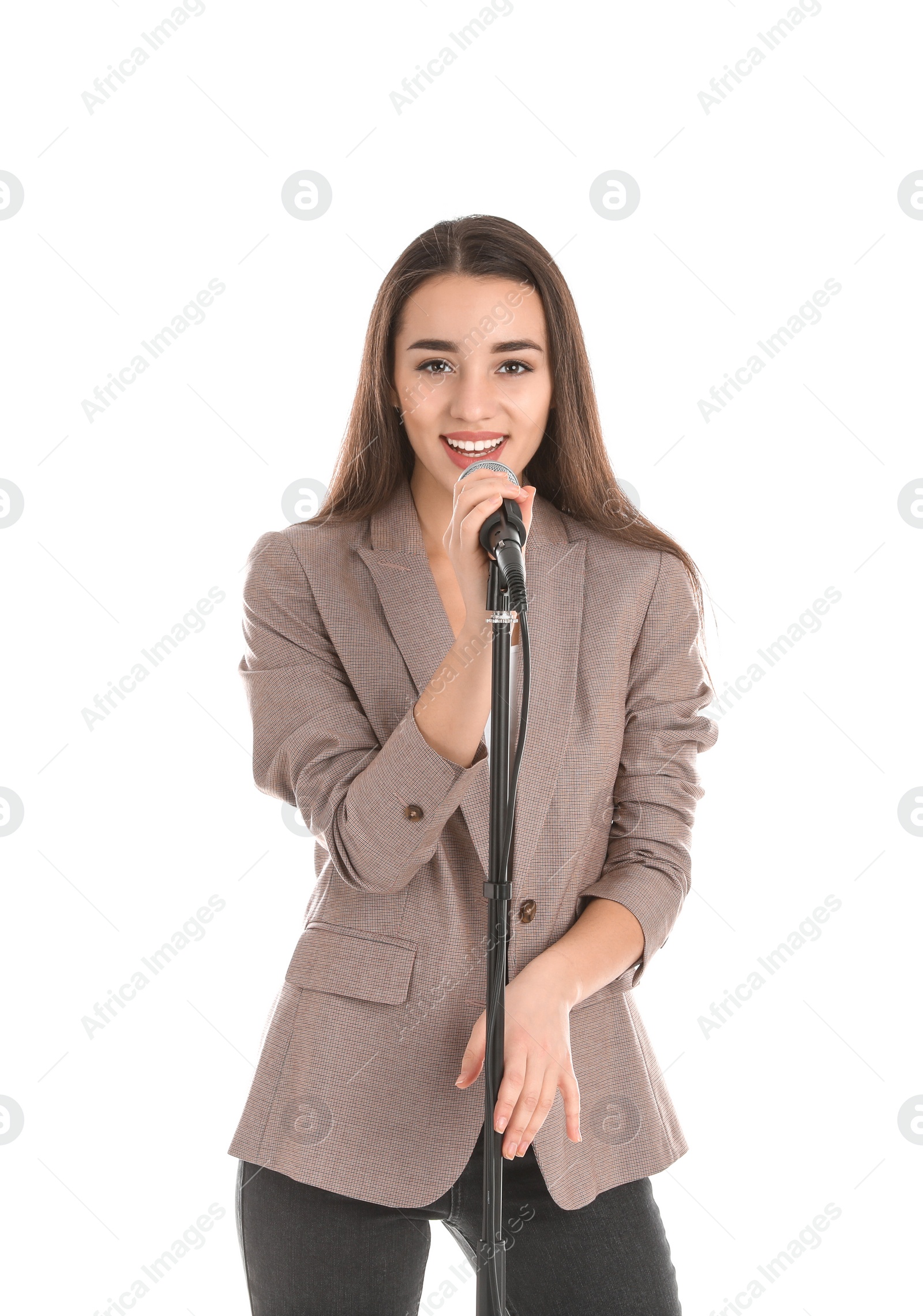 Photo of Young stylish woman in jacket with microphone on white background