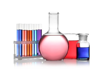 Photo of Set of different lab glassware with color liquid isolated on white