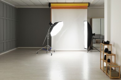 Photo of White photo background and professional lighting equipment in studio