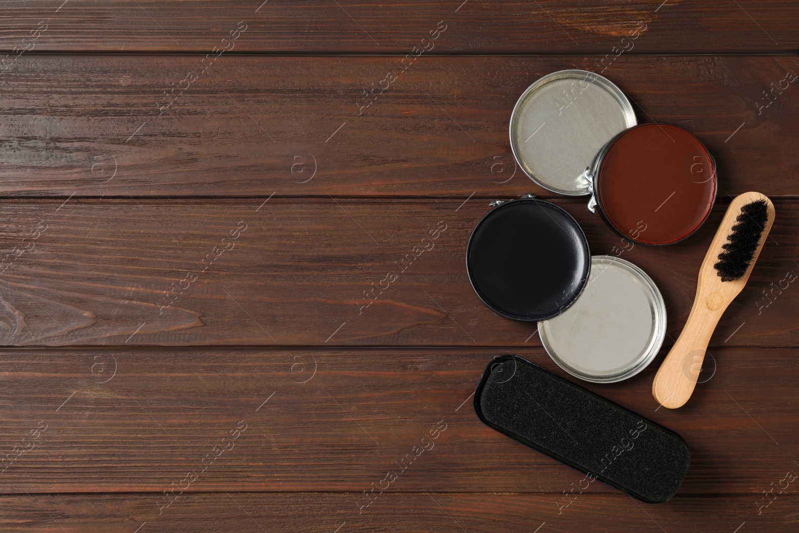 Photo of Flat lay composition with shoe care accessories on wooden background, space for text