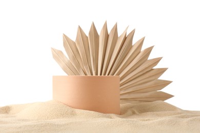 Photo of Presentation of product. Beige podium and palm leaf on sand against white background