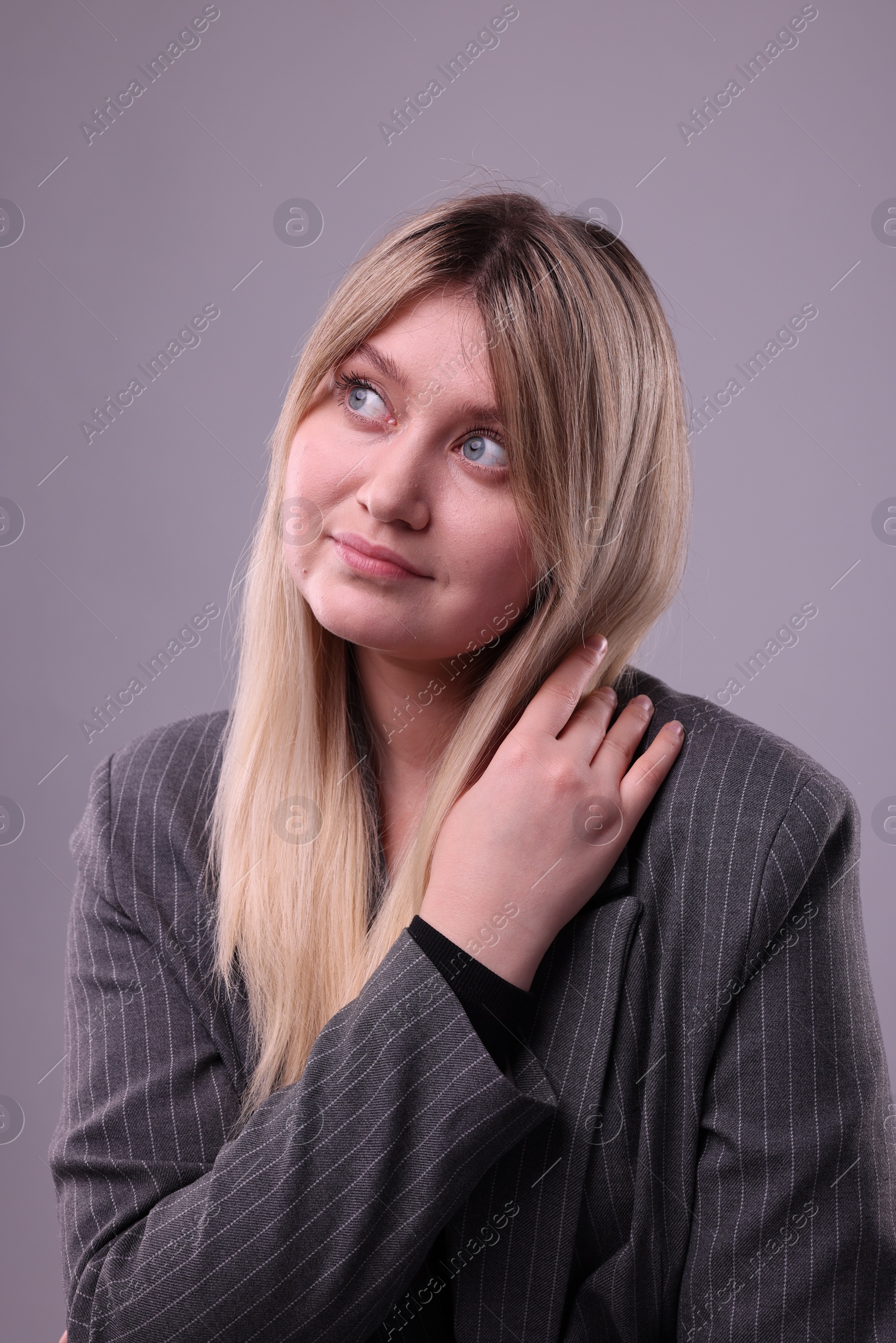 Photo of Portrait of beautiful young woman on grey background