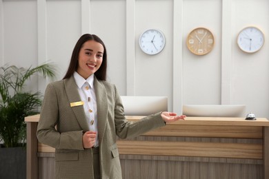 Portrait of beautiful receptionist near counter in hotel