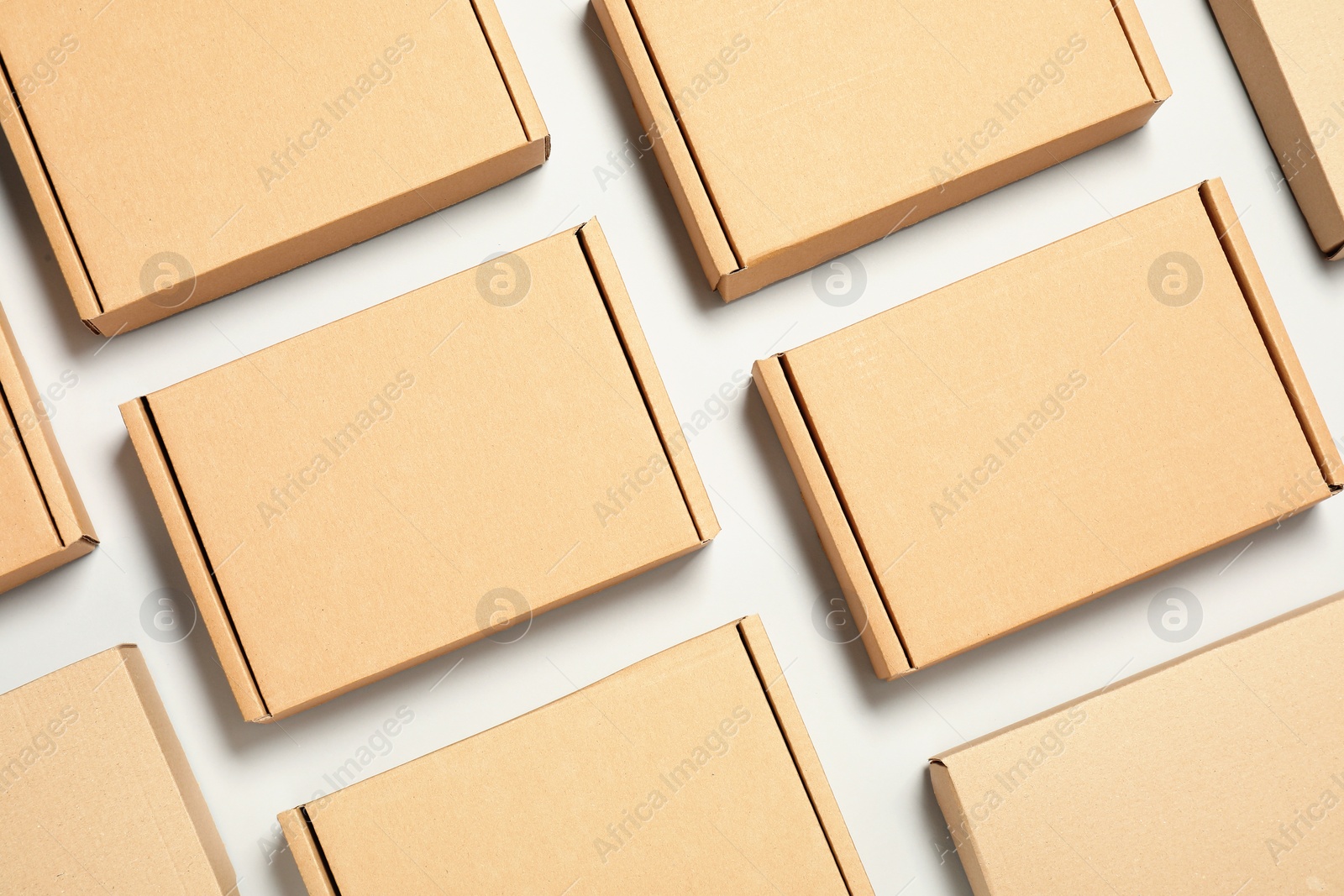 Photo of Many cardboard boxes on white background, flat lay. Packaging goods