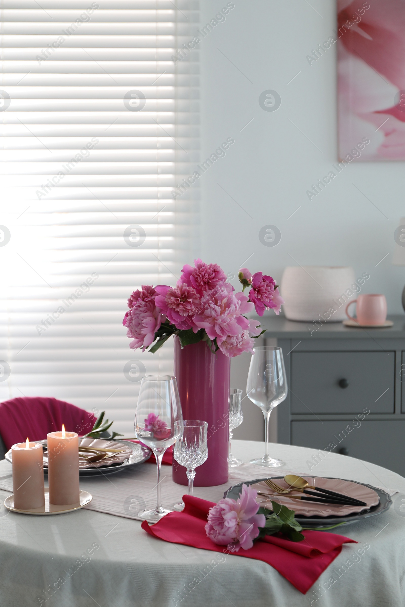 Photo of Beautiful table setting with pink peonies and burning candles