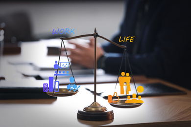 Work-life balance concept. Scale with images on table