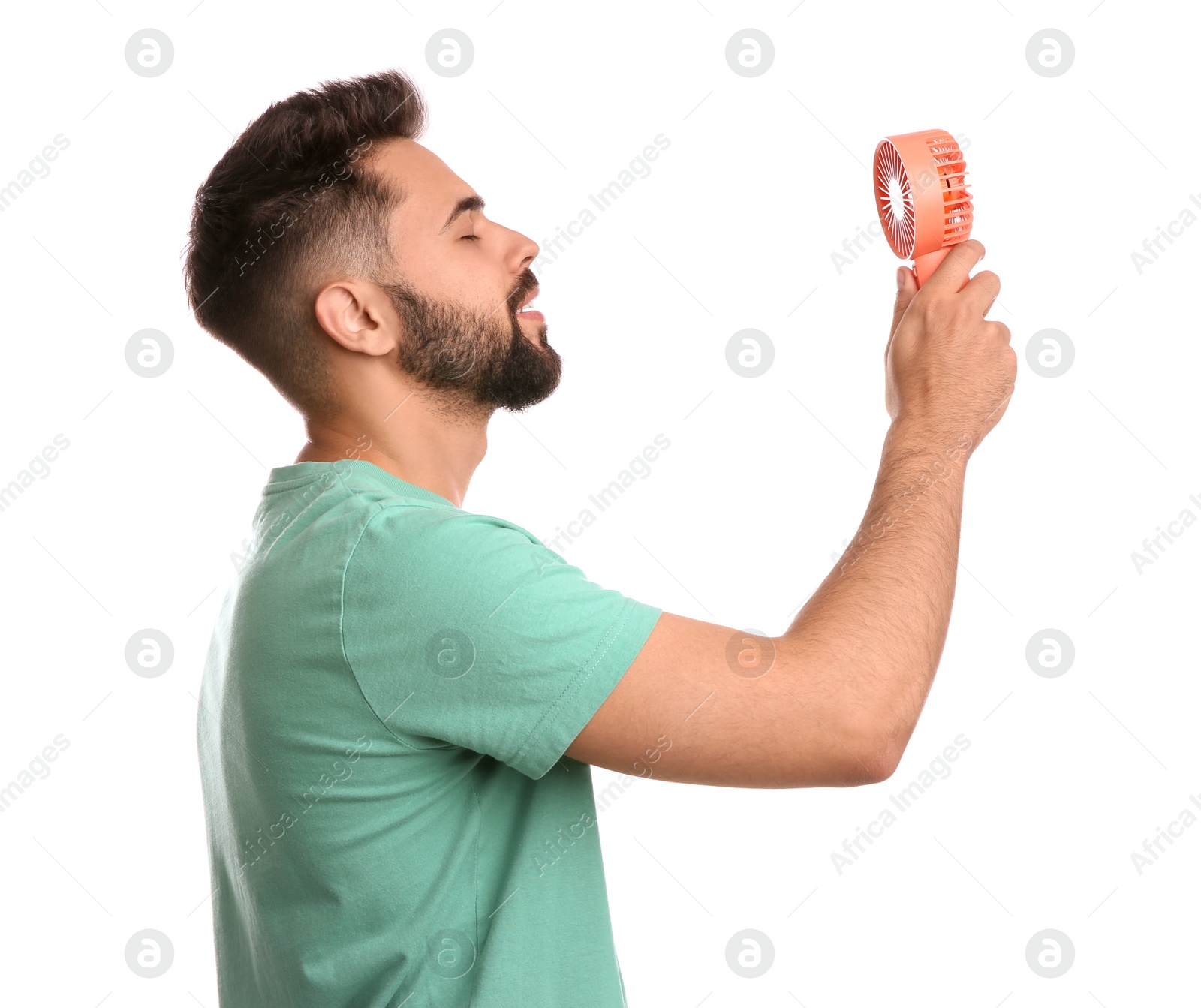 Photo of Man enjoying air flow from portable fan on white background. Summer heat