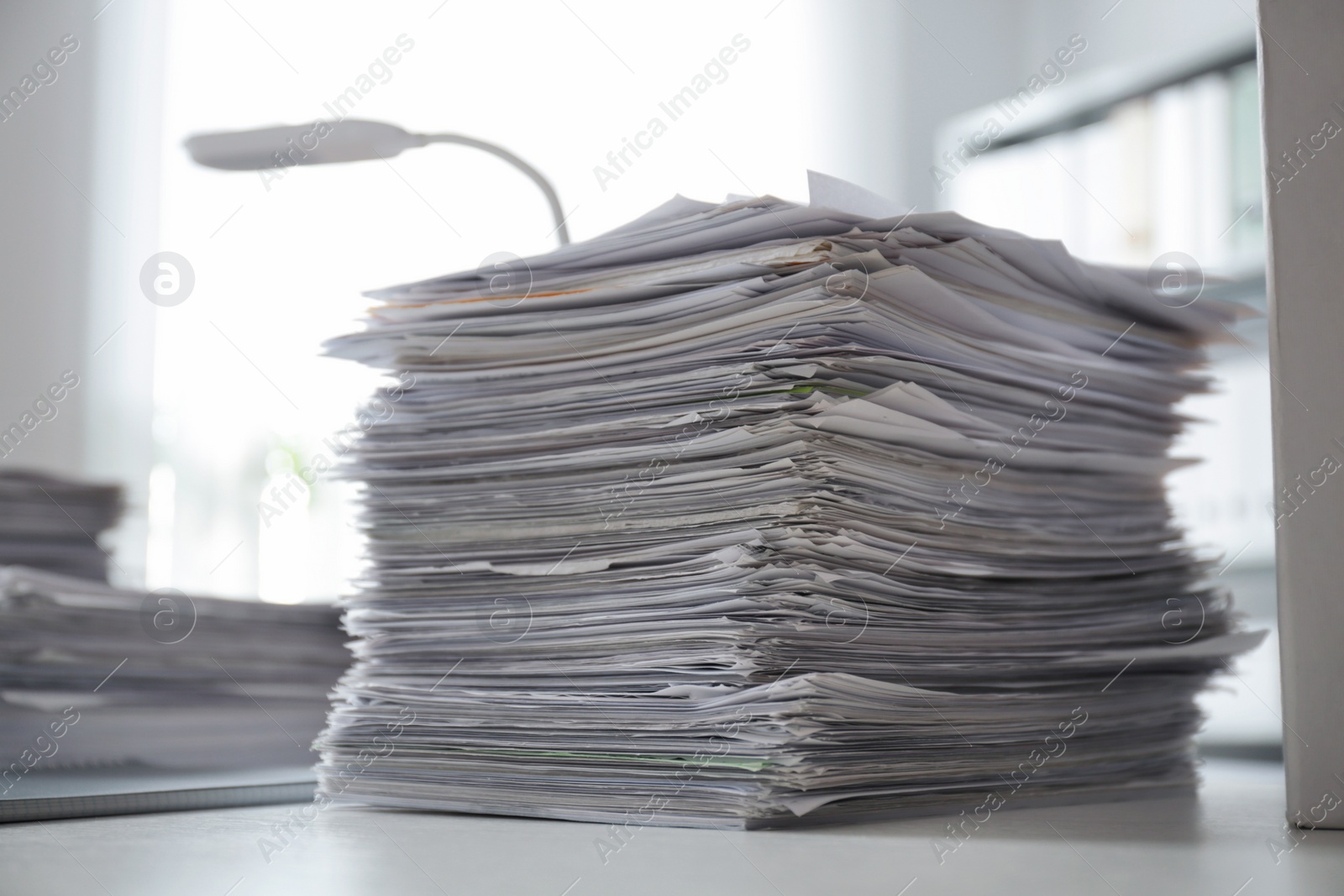 Photo of Stack of documents on desk in office