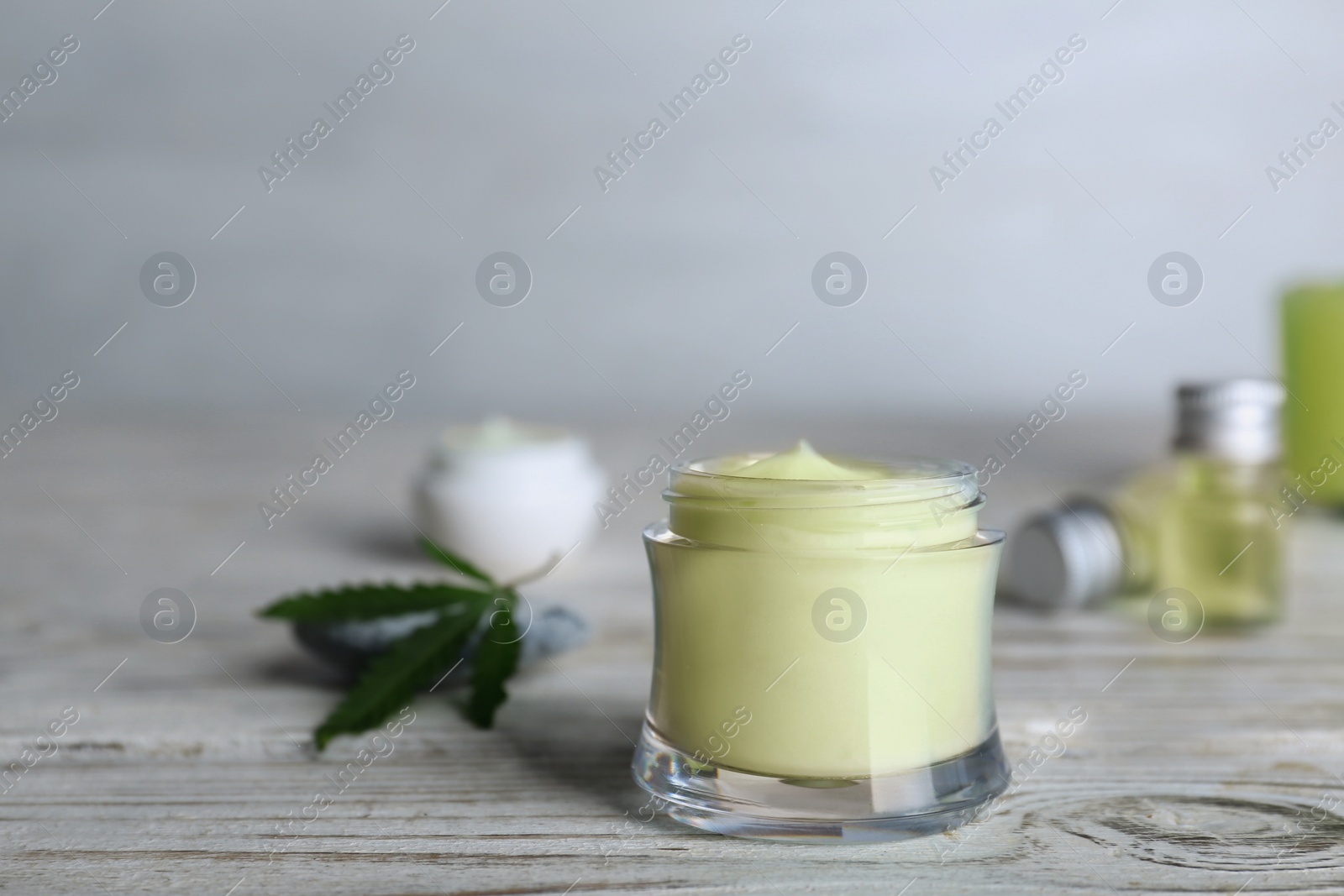 Photo of Jar of hemp lotion on wooden table